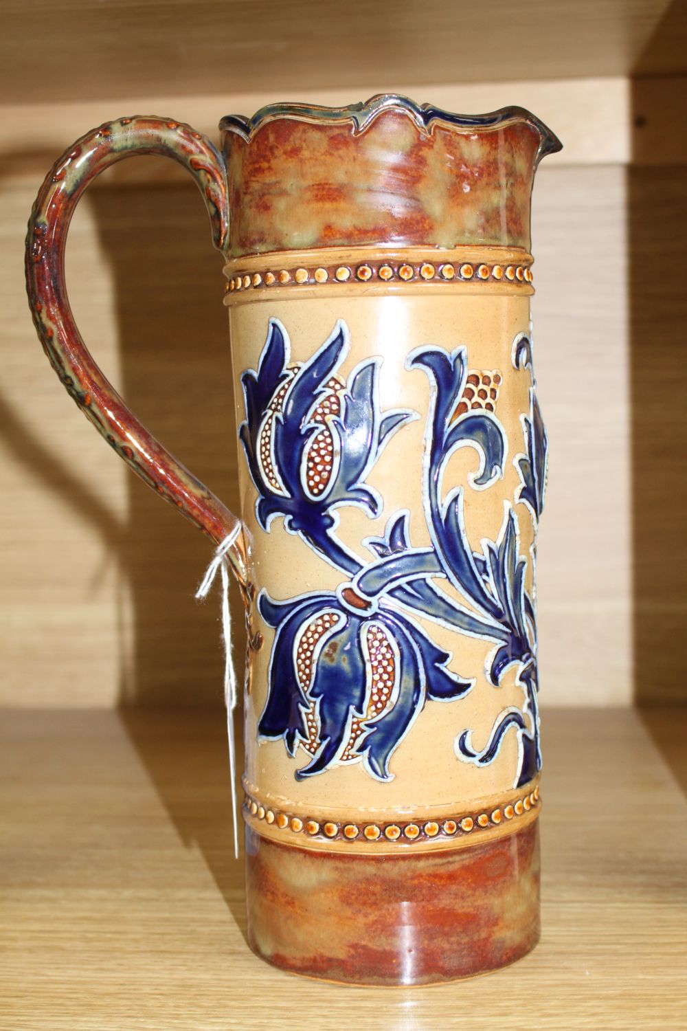 Mark V. Marshall for Doulton Lambeth, an Art Union of London jug, c.1895, the cylindrical body tube-lined with spikey flower and leaves